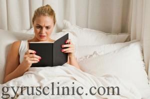 Woman reading book in bed