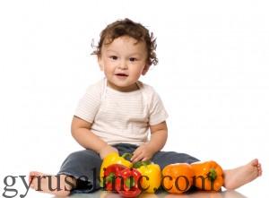 The child with paprika,isolated on a white background.