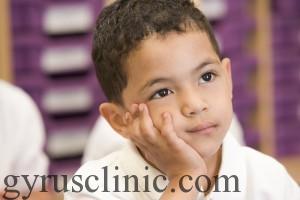 Schoolboy sitting in primary class