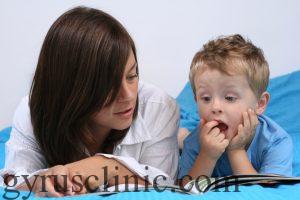 mother and three years old boy reading book - good night